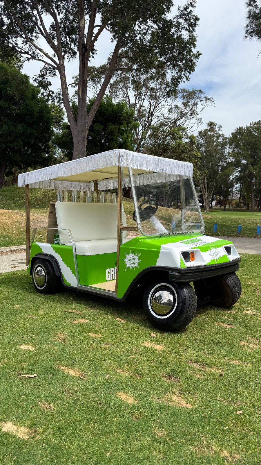 Players and the Jimmy Slings crew around the buggy bar on the fairway